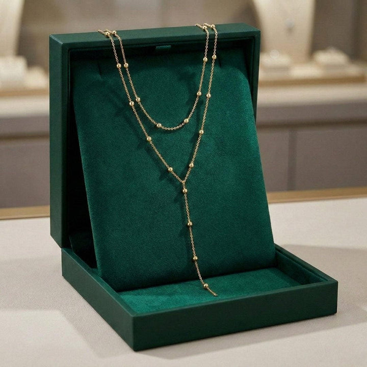 Collar de cuentas con borlas largas de doble capa dorado