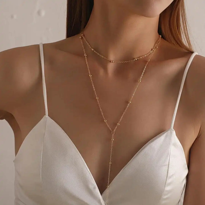 Collar de cuentas con borlas largas de doble capa dorado